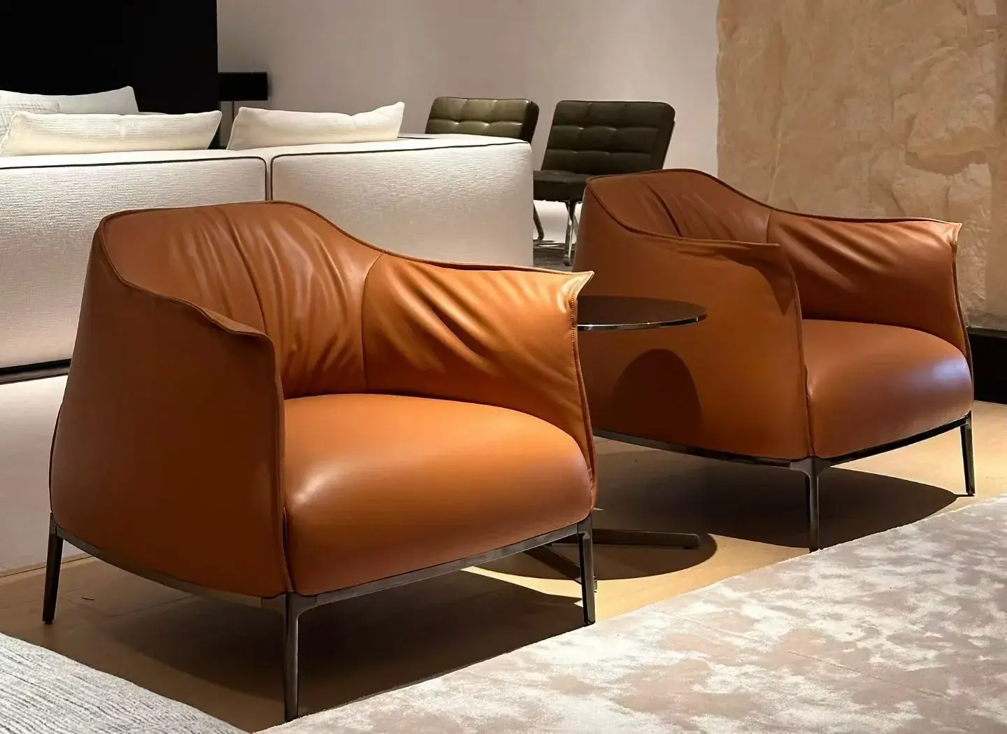 Caramel leather armchair on a dark metal frame