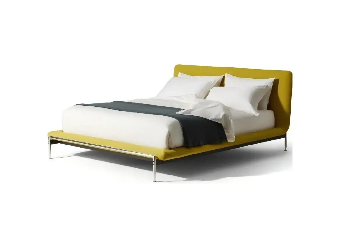 Mustard-toned upholstered bed with a curved headboard and slim metal base