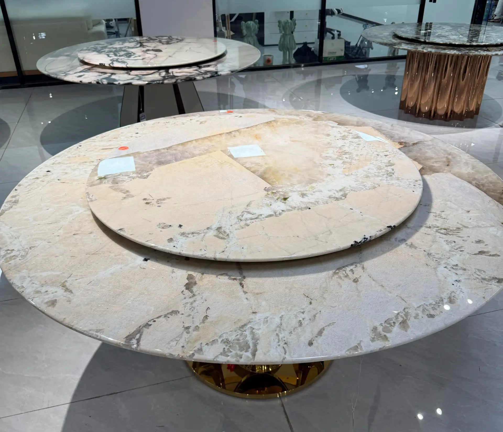 Round marble dining table with a smaller circular serving tray