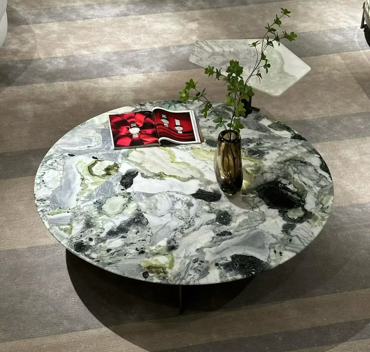 Round green-veined marble coffee table on a metal base