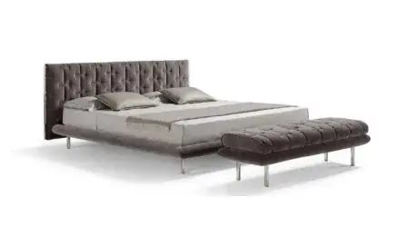 Upholstered bed and matching padded bench shown together
