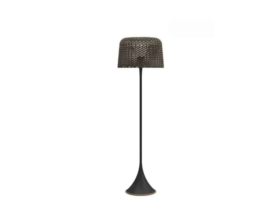 Standing floor lamp with a dark woven shade, slender stem and flared base