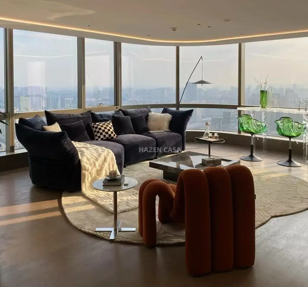 Living-room seating beside large windows with a floor lamp extending a long angled arm over the group